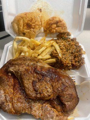 2 pork steaks, fries, jambalaya, and bread.