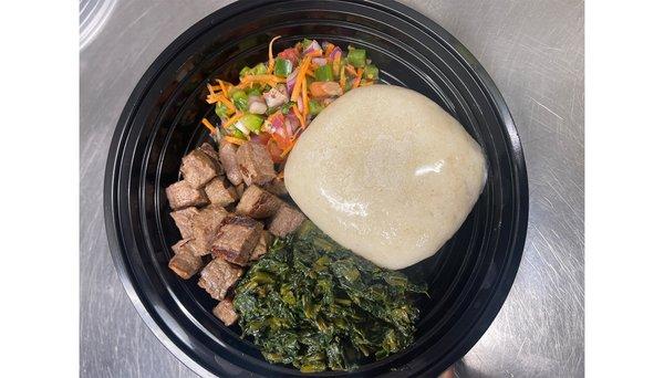 Nyama choma (grilled steak bites), ugali, greens