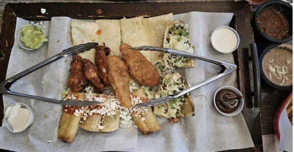 Sampler plate for two. Quesadillas, stuffed potato skins, wings, chicken strips, & flautas. Comes with ranch, BBQ, guac, & sour cream