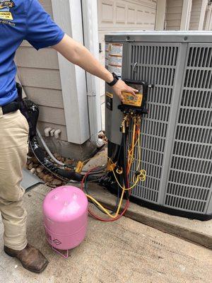 Adding refrigerant.