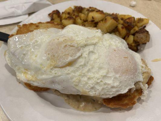 Country fried steak and eggs over easy