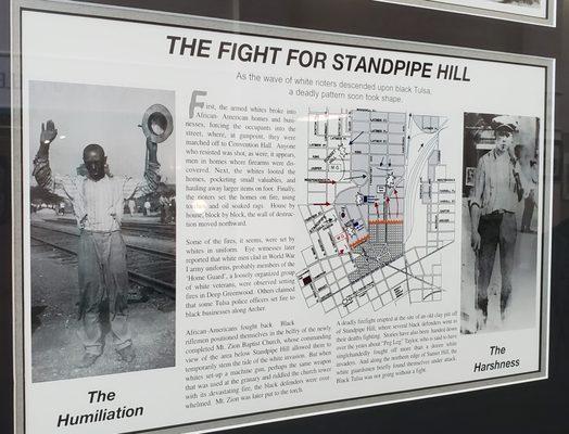 Framed displays on the walls about the Tulsa Race Massacre