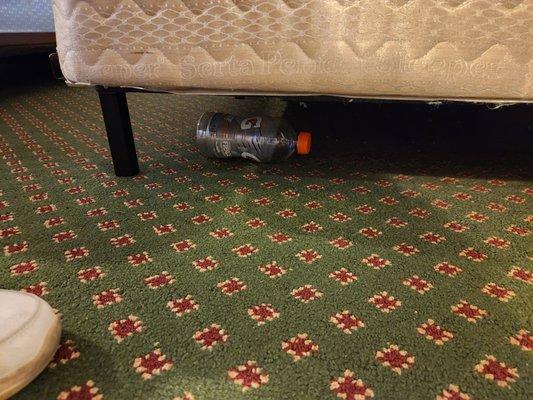 Empty beverage under bed.