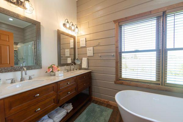 New bath remodeling with double vanity and tub with floor