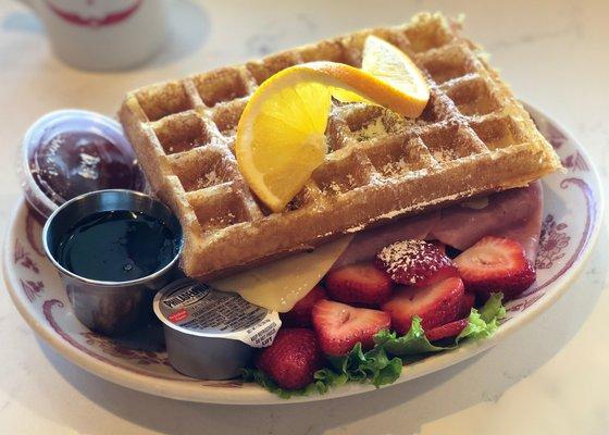 Brussels Belgian! Monte Cristo style waffle Stuffed with ham, turkey and swiss cheese. Served with strawberry preserves  & cream cheese.