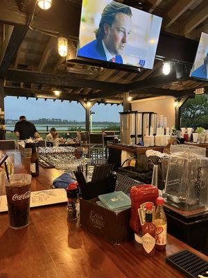 Outdoor bar with live music and views of the Marsh