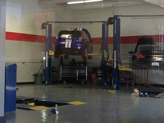 The view from our waiting room - a Ford Fiesta ST getting a new exhaust installed, Porsche getting suspension