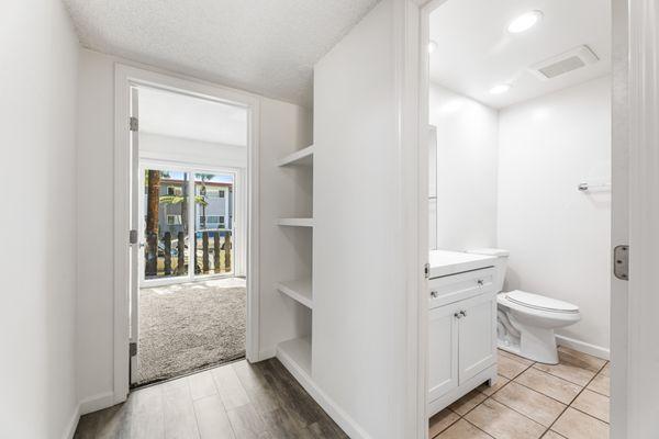 Bath, built-in hallway storage, bedroom with private balcony