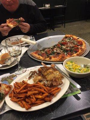 Partly eaten "the Works" pizza, soft shell crabs with sweet potato fries, side of succotash