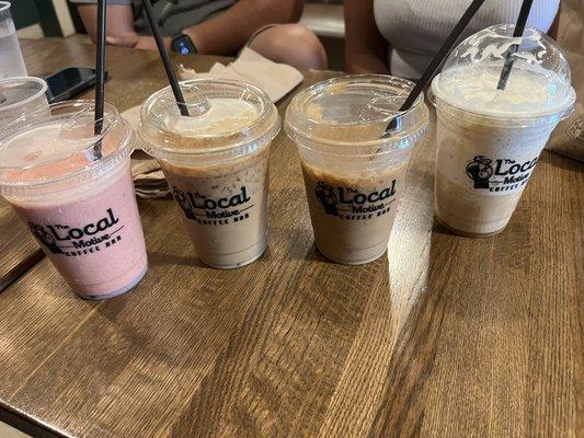 Left to right: strawberry smoothie, 2 iced caramel macchiatos with oat milk, caramel frappe