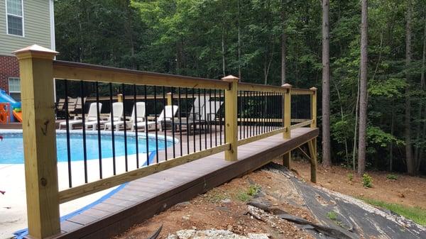 Custom Hand Rail with gate installation for a pool deck.