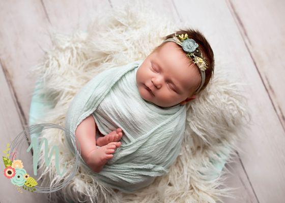 Newborn girl in light blue wrap at Mobie Photo in Pleasant Grove, Utah