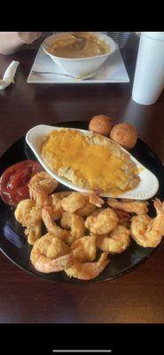 Fried shrimp, cheesy mashed potatoes and the background is one of their soups.