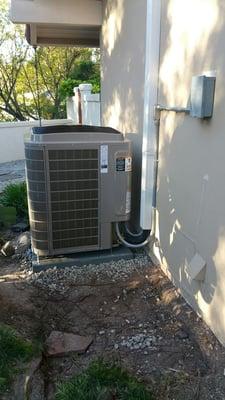 We removed the old concrete slab and relocated the new condenser to leave the plumbing access open