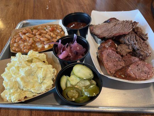 Shiner, bock beans, potato salad, brisket, German sausage, pickled red onion, homemade pickles, and jalapeños