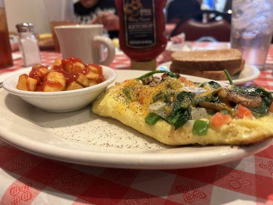 Veggie omelet with hash browns, toast, and coffee