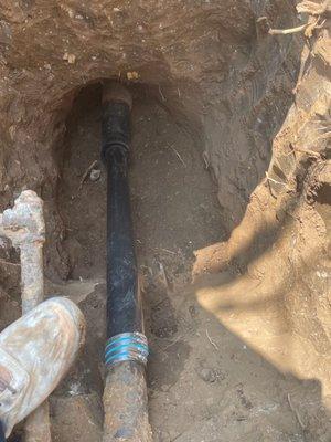 Connection between cleared and newly lined sewer lateral to the city main and the building drain + cleanout