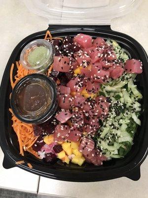 Tuna poke bowl with beets mango seaweed salad cucumber sesame seeds carrots wasabi chili sauce on white rice