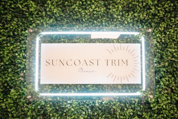 Glowing Sign of Suncoast Trim Clinic