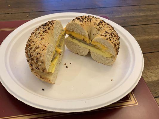 Egg and cheese sandwich with sausage on an everything bagel