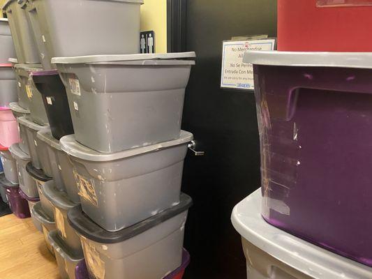 Bins blocking restroom door; in an emergency someone could get trapped.