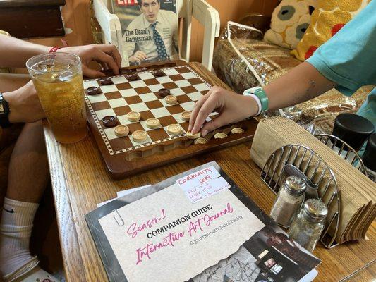 Bored? Four shelves of board games to enjoy before or after dining.