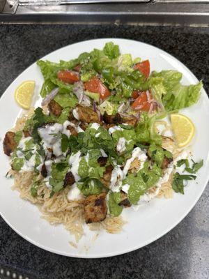 Homemade chicken over brown rice with yogurt sauce, and homemade spicy green sauce I get yesterday again it's really delicious