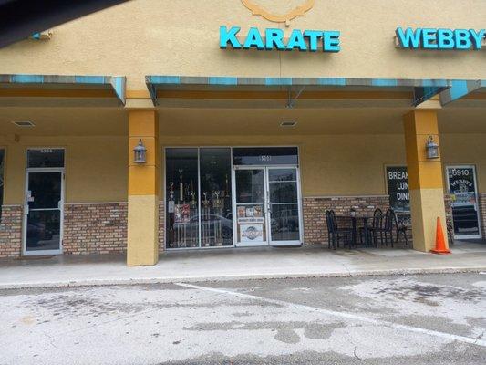 Under the blue Karate sign, a life-changing experience awaits.