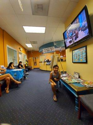 Waiting area with magazines to read and TV