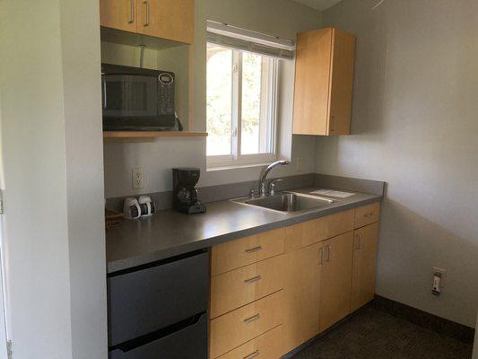 Kitchenette with a microwave, coffee maker, mini fridge and freezer.  They're also were snacks and drinks available for free in the room.