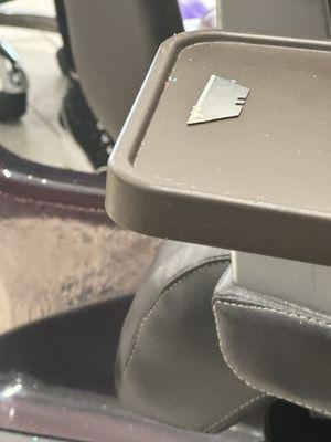 A razor blade found on a customer's chair/tabke