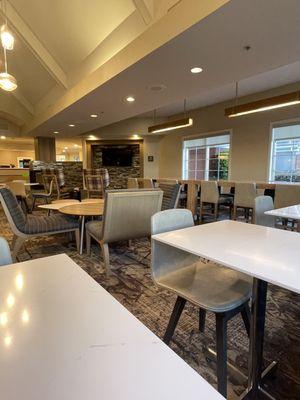 Breakfast dining/lobby/business tables across from check in