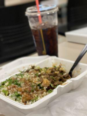 Double meat asada burrito bowl with extra cabbage, onion, and cilantro with red salsa on top.