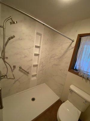 kohler shower and luxstone walls