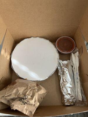 Nicely packaged enchiladas, in a bakery box with tortillas, chips and salsa.