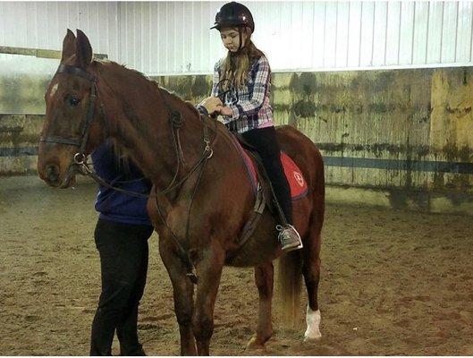 First lesson at La Fleur's stable. Neva is taking the time to show her everything she needs to know before she starts riding.