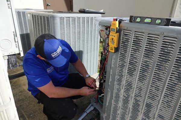 Service Technician is solving an air conditioning problem for a homeowner.