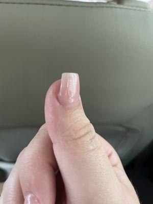 Filed down completely and does not follow the shape of the nail.