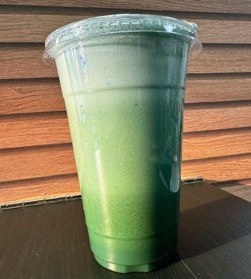 Fresh pressed Feeling Healthy Juice with a scoop of spirulina powder