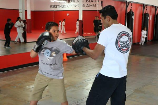 Pretty awesome coincidence that Coach Carlos is training someone with a shirt saying "diamond".  Kids boxing session at the gym.