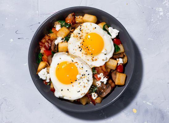 Hash Bowl: Crispy potatoes, bacon, peppers, onions, mushrooms, goat cheese, two eggs your way, topped with everything bagel seasoning.