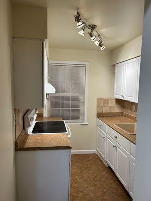 Kitchen with new base cabinet (right side) and paint (After)