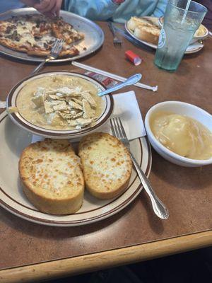 Soup and garlic bread special with mashed potatoes, pictured behind is cauliflower pizza