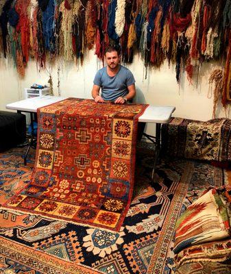 Owner and master restorer Fazli Solak works on a circa 1800 rug from the Tarim Basin in East Turkestan / Northwest China for a client.