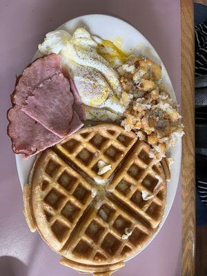 Two eggs, smashbrowns, ham and waffles