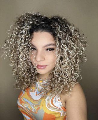 Curly cut with blonde highlights