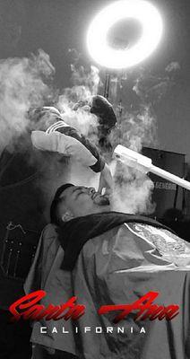 Using our special steamer to open up the pores and give our clients a smooth beard shave.