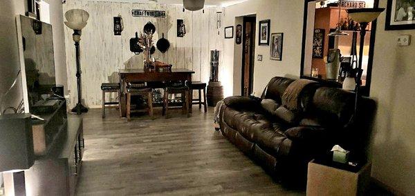 Replaced dark wood flooring and carpet with all laminate plank in living room, dining room, kitchen and hallway.