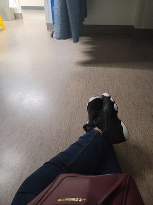 Sitting on an emergency room floor because they have no chairs. It's obviously a skeleton crew.