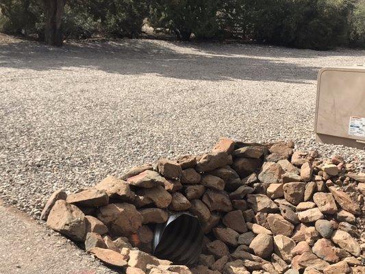 Replaced culvert due to it being clogged with mud. Positioned  the rock near culvert as well